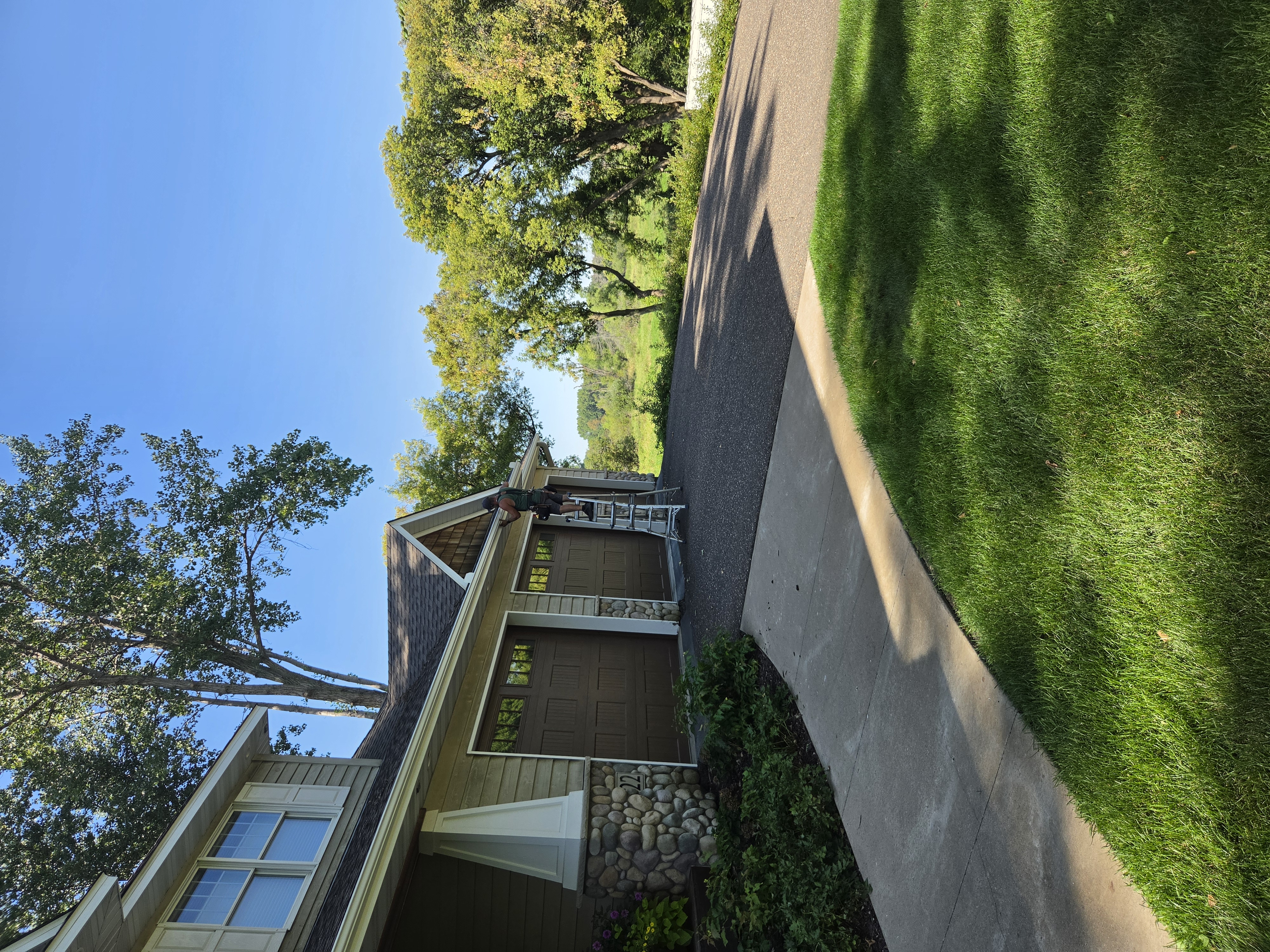 View of a home's front porch, roofline, and gutter system